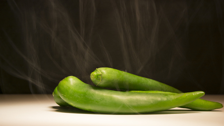 Roasting hot green peppers, cooking peppers, spicy foodの写真素材