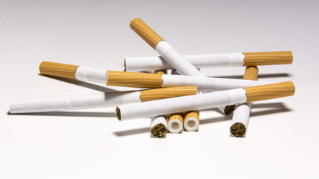 Cigarette on white background, unhealthy lifestyle, toxic nicotineの写真素材