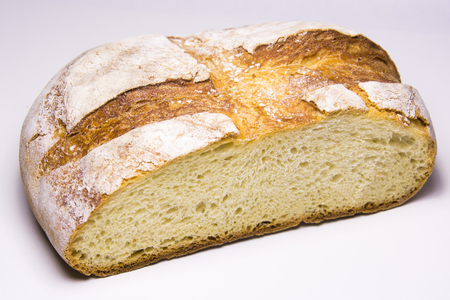 Freshly baked traditional round bread on white background.の写真素材