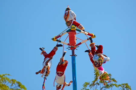 TULUM, MEXICO - NOVEMBER 2, 2010: Maya Indian street performers a.k.a Flying Mayans performing Maya Cultural traditional stunts on November 2, 2010 in Tulum, Mexico by Maya Ruins Archaeological Site.のeditorial素材