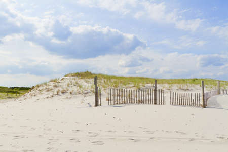 Sand dunes on Atlantic coast with a fence.の写真素材