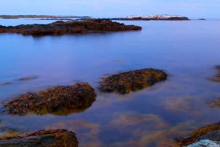 Sunset on a rocky shoreの写真素材