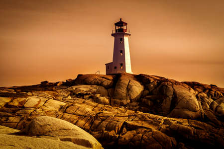 Lighthouse on a rocky shoreの写真素材