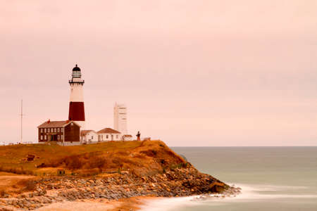 Lighthouse on a rocky shoreの写真素材