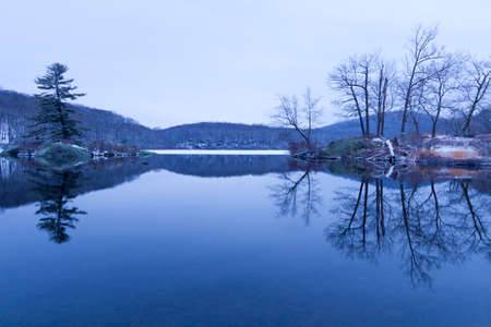 Beautiful view of sunset on the forest lake.