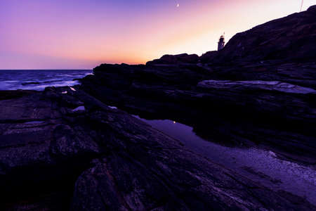 Beautiful sunset on a rocky ocean shoreの写真素材
