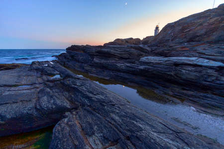 Beautiful sunset on a rocky ocean shoreの写真素材