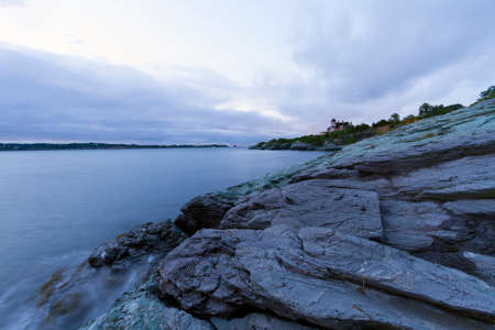 Beautiful sunset on a rocky ocean shoreの写真素材