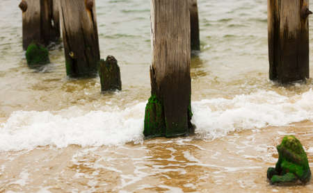 Old jetty in the ocean wave splash.の写真素材