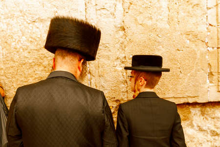Jerusalem, Israel-March 14, 2017: Jews pray at The Western Wall - the holiest place where Jews are permitted to pray, though it is not the holiest site in the Jewish faith, which lies behind it, on Temple Mount.のeditorial素材