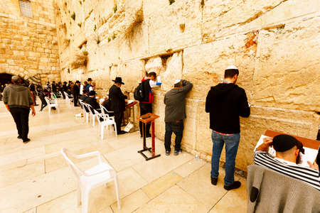 Jerusalem, Israel-March 14, 2017: Jews pray at The Western Wall - the holiest place where Jews are permitted to pray, though it is not the holiest site in the Jewish faith, which lies behind it, on Temple Mount.のeditorial素材