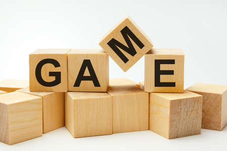 GAME - word from wooden blocks on a white background