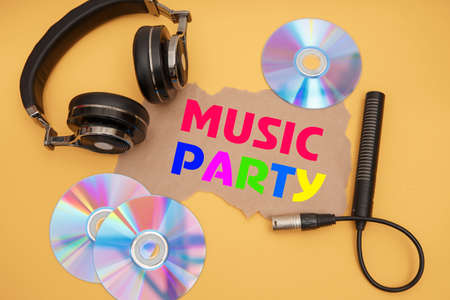 Headphones, microphone and music discs on a yellow background. Inscription MUSIC PARTY.