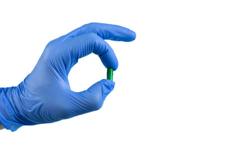 Tablets in the hand. Hands in medical gloves. Isolate. Medicines in the hand.