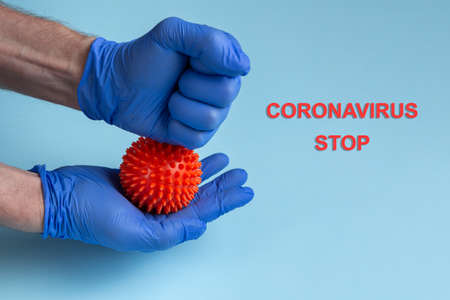 The concept - Stop coronavirus. STOP CORONAVIRUS text. Virus in the handsの写真素材