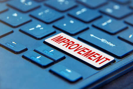 Laptop computer keyboard with Improvement Button. Concept means continuous action to improve productsの写真素材