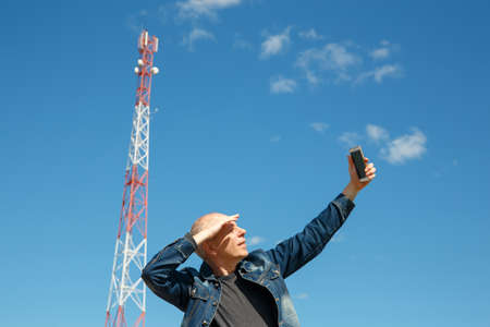 Man is trying to catch a mobile network signal. 3G 4G signal is very low.の写真素材