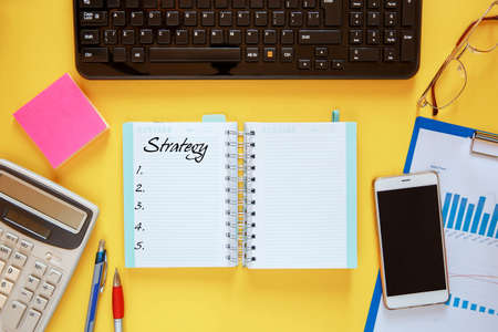 Workspace office desk - flat lay photo on top of workspace with blank note mockup on yellow...