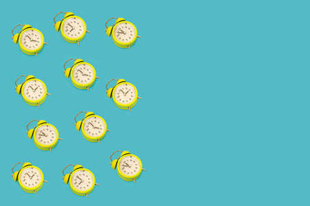 A lot of classic style alarm clock isolated on light blue background and copy space. Smile time...