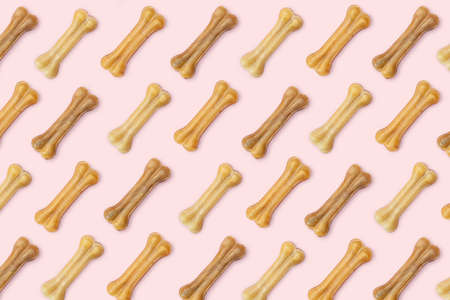 Pink background of many dog goodies in the form of a bone.の写真素材