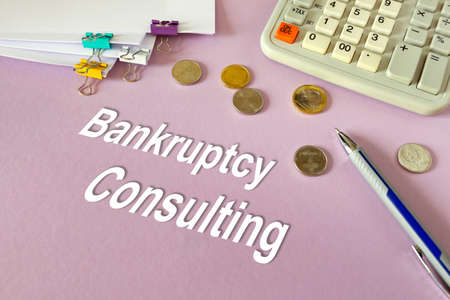 Concept: Bankruptcy Consulting. Calculator, money and documents on the tableの写真素材