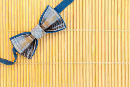 Bow tie on a background of straw. Background for design.の写真素材