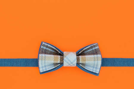 Handmade bow tie on an orange background. Background for design.の写真素材