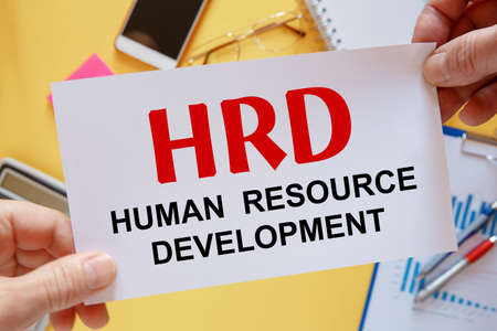 Office desktop - flat lay photo from above. Caption - HRD human resource development.の写真素材
