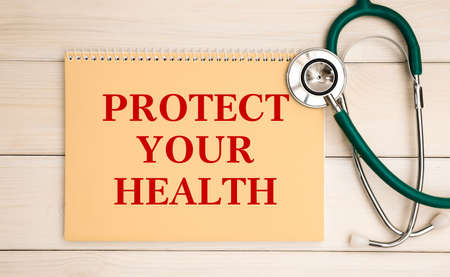 Card with text Protect Your Health and stethoscope, medical concept.の写真素材