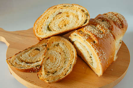 Appetizing homemade bread with spinach and sprinkled with sesame seeds.