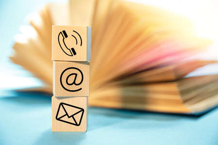 Website and Internet contact icons on the background of an open bookの写真素材