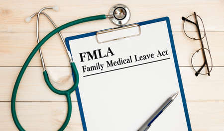 Paper with Family Medical Leave Act FMLA on the office deskの写真素材
