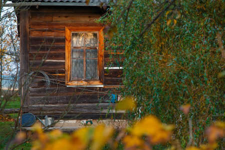 Window and part of an old rural house. Country life in an old wooden house in Russia.