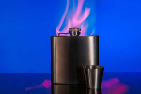 Metal flask for strong alcoholic drinks with a metal glass.の写真素材