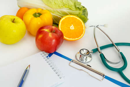 Nutrition and healthy eating. Fruits, vegetables, juice and stethoscopeの写真素材
