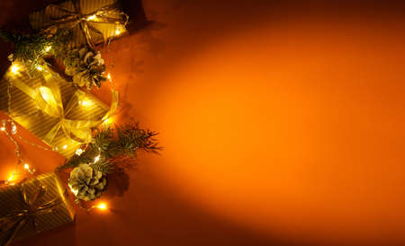 Christmas or new year composition, terracotta background and golden christmas decorations and gifts