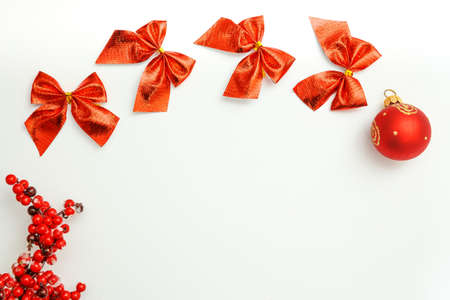Red Christmas decorations on a white background to create a greeting card.の写真素材
