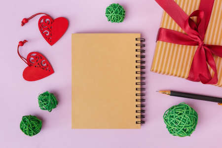 A notebook for a greeting inscription, a gift and hearts on a pink background. Valentine's Day and other holidaysの写真素材