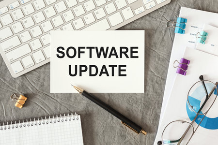 Software Update is written in a document on the office desk with office accessories.
