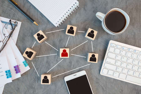 Organization structure, team building, recruitment, management and human resources concepts. Person icons on wooden cubes linked to each other.の写真素材