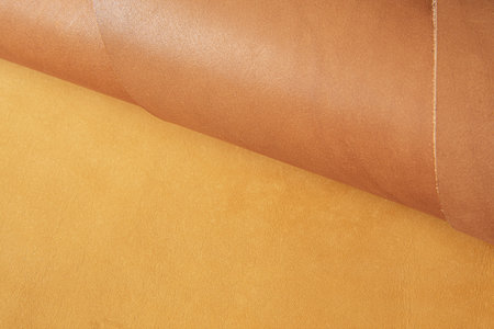 Combined background from natural light brown and dark brown leather