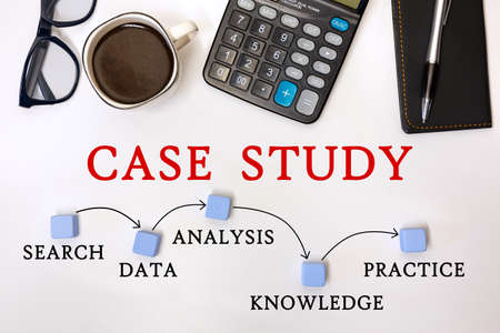CASE STUDY MILESTONES CONCEPT. Office desk with accessories - coffee, notepad and calculatorの写真素材