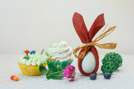 Easter holiday dessert table with cupcakes, eggs and sweets.