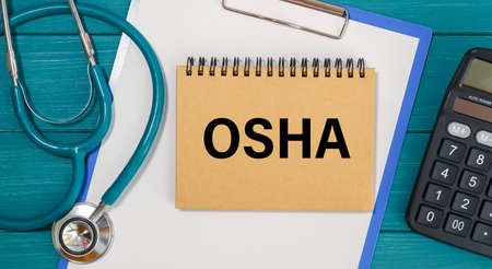 Notepad with the inscription OSHA and stethoscope. Medical concept.の写真素材