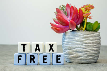 Soft cubes with the abbreviation TAX FREE with a flower on a white backgroundの写真素材