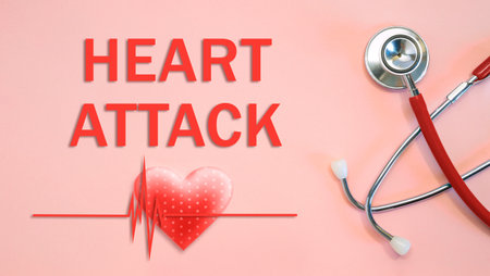 HEART ATTACK concept with stethoscope and heart shape on a pink backgroundの写真素材