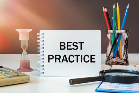 BEST PRACTIICE is written on a notepad on an office desk with office accessories.の写真素材