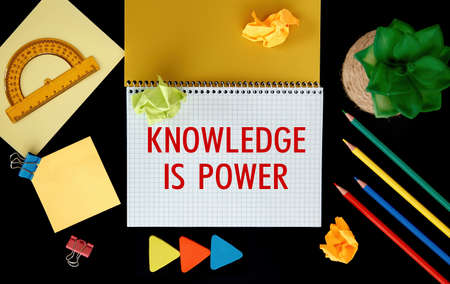 Open notebook with school supplies and the inscription KNOWLEDGE IS POWERの写真素材