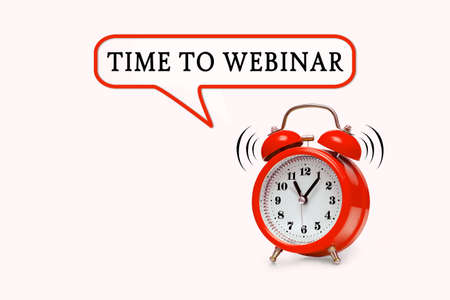 TIME TO WEBINAR - text on light pink background with red alarm clockの写真素材