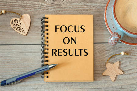 Focus on results is written on a notepad, on an office desk with office accessories.の写真素材